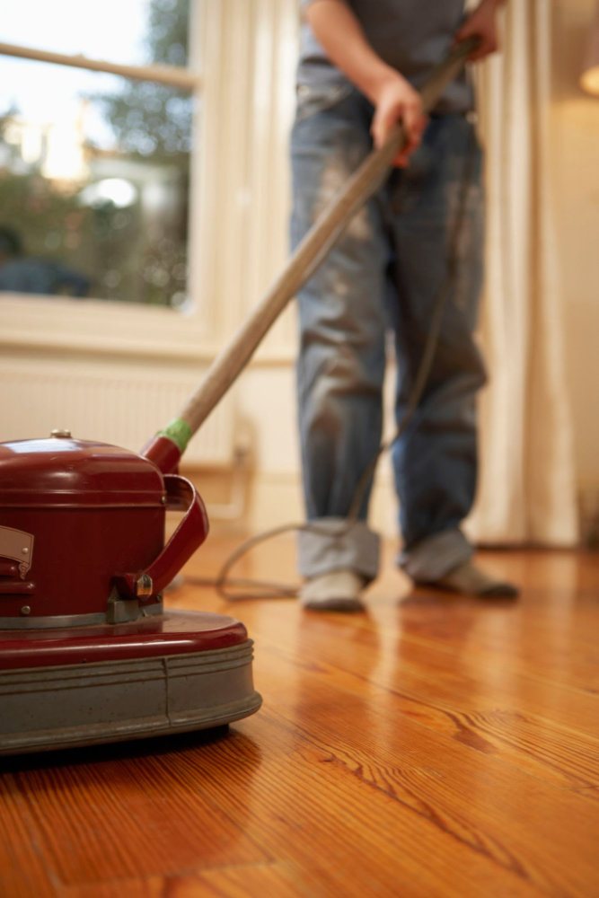 A professional restoring timber floors