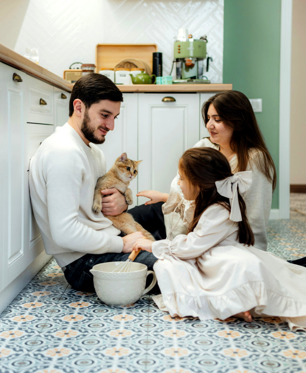 A young family in a pastel decorated kitchen
